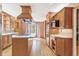 Spacious kitchen with wood cabinets, hardwood floors, kitchen island and stainless steel appliances at 12258 E Lasalle Pl, Aurora, CO 80014