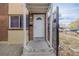 Brick building exterior with covered entry and gated walkway at 1628 Chester St, Aurora, CO 80010