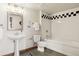 Clean bathroom with pedestal sink and checkerboard tile at 2955 Inca St # 1D, Denver, CO 80202