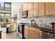 Modern kitchen with light wood cabinets, stainless steel appliances, and an island at 2955 Inca St # 1D, Denver, CO 80202