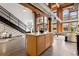 Open concept kitchen and staircase with exposed beams and high ceilings at 2955 Inca St # 1D, Denver, CO 80202