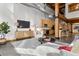 Open living area with high ceilings, exposed beams, and modern furniture at 2955 Inca St # 1D, Denver, CO 80202