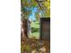 Spacious backyard with lush green grass, mature trees and a charming wooden fence with gate at 10810 Summerset Way, Parker, CO 80138