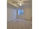 Bright bedroom featuring neutral carpet and a large window, creating a cozy and inviting space at 10810 Summerset Way, Parker, CO 80138