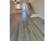 Open floor plan featuring modern laminate flooring and staircase at 10810 Summerset Way, Parker, CO 80138