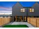 Modern backyard patio and fenced yard with sliding glass doors and professional landscaping at 2478 S Cherokee St, Denver, CO 80223