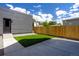 Modern home featuring a cozy backyard with a small patch of grass and a privacy fence at 2478 S Cherokee St, Denver, CO 80223