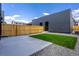 Charming backyard with concrete patio, small lawn, privacy fence, and modern siding at 2478 S Cherokee St, Denver, CO 80223