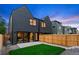 Modern backyard patio and fenced yard with sliding glass doors and professional landscaping at 2478 S Cherokee St, Denver, CO 80223