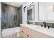 Modern bathroom with double sink vanity, gray tiled shower, and sleek fixtures at 2478 S Cherokee St, Denver, CO 80223