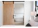 Luxurious ensuite bathroom showcasing a modern barn door, soaking tub, and sleek finishes at 2478 S Cherokee St, Denver, CO 80223