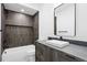 Modern bathroom with dark gray tiled shower and vessel sink at 2478 S Cherokee St, Denver, CO 80223