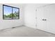 Bright, minimalist bedroom with large window and closet doors, offering a clean and simple design at 2478 S Cherokee St, Denver, CO 80223