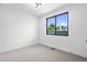 Bright bedroom with large window and plush carpeting at 2478 S Cherokee St, Denver, CO 80223