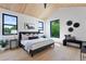 Bright bedroom with a vaulted wood ceiling, large windows, and stylish, neutral décor at 2478 S Cherokee St, Denver, CO 80223