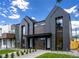 Modern duplex with dark siding, large windows, and professional landscaping at 2478 S Cherokee St, Denver, CO 80223