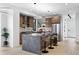 Sleek kitchen with stainless appliances, island seating, wood cabinets, and open shelving at 2478 S Cherokee St, Denver, CO 80223