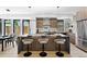 Stylish kitchen with a large island, modern pendant lighting, stainless steel appliances, and seating for three at 2478 S Cherokee St, Denver, CO 80223