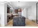 Open kitchen featuring a gray island with seating, wooden cabinets, stainless appliances, and recessed lighting at 2478 S Cherokee St, Denver, CO 80223