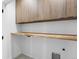 Functional laundry room with ample storage cabinets and folding counter at 2478 S Cherokee St, Denver, CO 80223