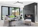 Cozy living room boasts a stone fireplace, large windows, and comfortable seating at 2478 S Cherokee St, Denver, CO 80223
