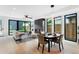 Open-concept living and dining area with a fireplace, modern decor, and bright natural light at 2478 S Cherokee St, Denver, CO 80223