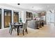 Bright, open-concept living space with modern kitchen, dining area, and sliding glass doors at 2478 S Cherokee St, Denver, CO 80223