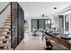 Open living space features a modern staircase, outdoor access, and a sleek kitchen view at 2478 S Cherokee St, Denver, CO 80223