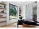 Bright home office features built-in shelving, a large window with tree views, and modern design at 2478 S Cherokee St, Denver, CO 80223