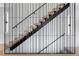 Modern staircase features floating wood treads, black metal railings, and white walls at 2478 S Cherokee St, Denver, CO 80223
