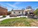 Backyard featuring a patio with outdoor seating, a fire pit, a lush lawn, and mature trees at 796 Ivanhoe St, Denver, CO 80220
