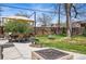 Spacious backyard featuring a patio with outdoor seating, a fire pit, a lush lawn, and mature trees at 796 Ivanhoe St, Denver, CO 80220
