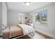 Cozy bedroom with wood floors, a window overlooking the yard, and access to an adjacent room at 796 Ivanhoe St, Denver, CO 80220
