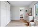 Versatile bedroom featuring white built-in cabinets, wood floors, and ample natural light from the window at 796 Ivanhoe St, Denver, CO 80220