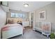 Charming bedroom with white furniture, soft pink accents, and plenty of natural light at 796 Ivanhoe St, Denver, CO 80220
