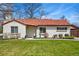 Charming single-story home with a red tiled roof, well-maintained lawn, and inviting curb appeal at 796 Ivanhoe St, Denver, CO 80220