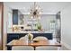 Elegant dining room showing the black and white kitchen island, countertops, and stainless steel appliances at 796 Ivanhoe St, Denver, CO 80220