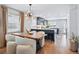 Bright kitchen and dining area with hardwood floors, modern light fixture, and black kitchen island at 796 Ivanhoe St, Denver, CO 80220