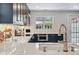 Modern kitchen with marble countertops, sleek dark cabinetry, stainless steel appliances, and herringbone backsplash at 796 Ivanhoe St, Denver, CO 80220