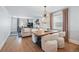 Open-concept living room with hardwood floors, modern lighting, and comfortable seating throughout at 796 Ivanhoe St, Denver, CO 80220