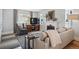 Comfortable living room area with a fireplace, plush seating, and natural light streaming through the windows at 796 Ivanhoe St, Denver, CO 80220