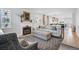 Cozy living room with a fireplace, comfortable seating, and an open view into the kitchen at 796 Ivanhoe St, Denver, CO 80220