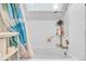 Clean bathroom with a shower and tub combo under a skylight, providing natural light at 8701 Huron St # 211, Thornton, CO 80260