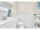 Bright bathroom with white tiled walls and a large mirror, with natural light from a skylight at 8701 Huron St # 211, Thornton, CO 80260