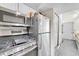 Modern kitchen with stainless steel appliances and white cabinetry providing ample storage at 8701 Huron St # 211, Thornton, CO 80260