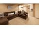 Finished basement Gathering room with sectional sofa and wet bar at 4236 Lark Sparrow St, Highlands Ranch, CO 80126