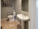 Clean and modern bathroom with pedestal sink and tile flooring at 4236 Lark Sparrow St, Highlands Ranch, CO 80126