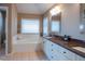 Elegant bathroom with double vanity, soaking tub, and separate shower at 4236 Lark Sparrow St, Highlands Ranch, CO 80126