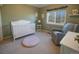 Bedroom with crib, armchair, and window seat at 4236 Lark Sparrow St, Highlands Ranch, CO 80126