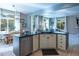 Kitchen island with seating and a view into the Gathering room at 4236 Lark Sparrow St, Highlands Ranch, CO 80126